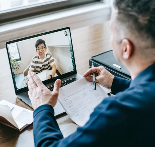 a man talking on a video call on his laptop