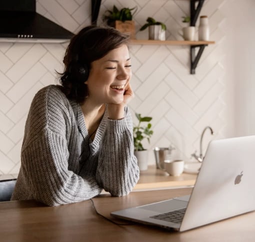 a woman talking on a video call on her laptop